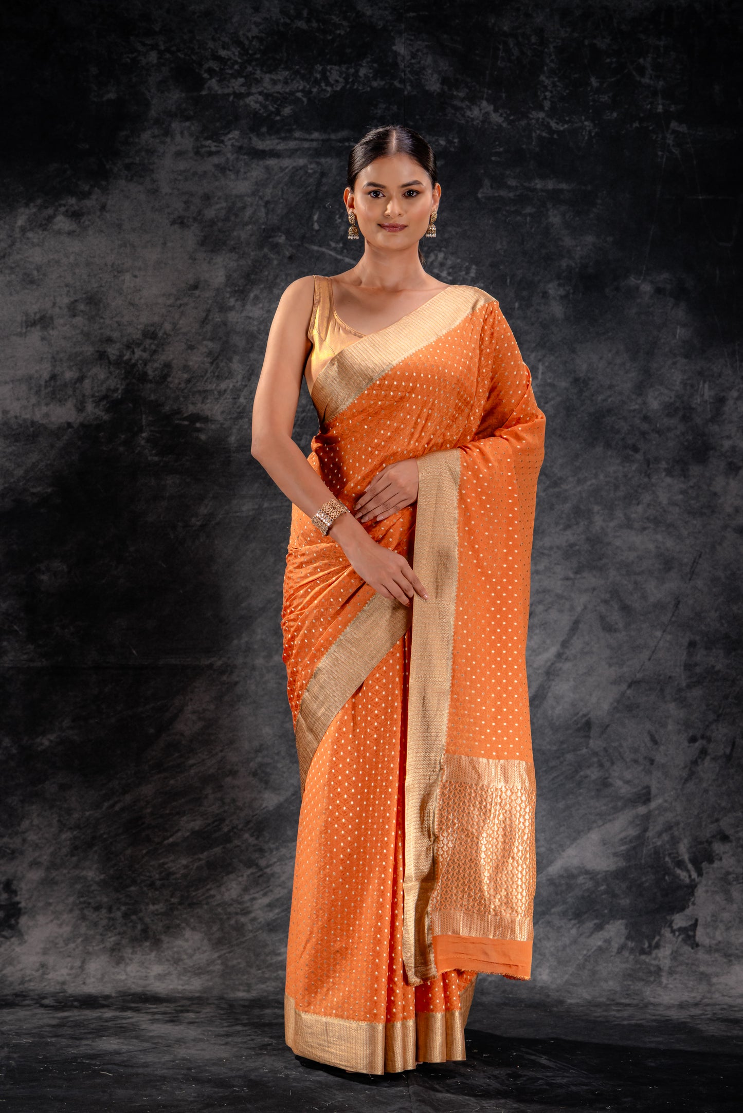 Burnt Orange Crepe Saree with Silver Buttas and Floral Jaal Texture