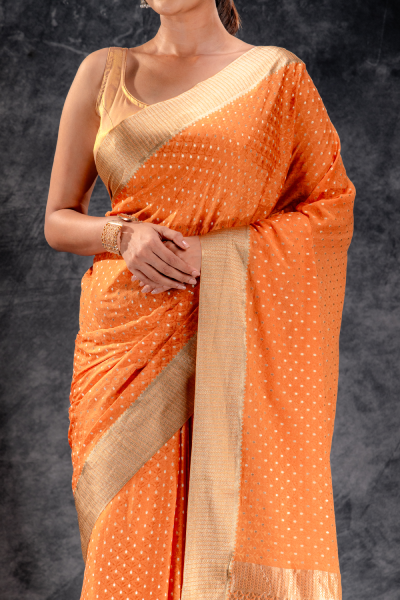 Burnt Orange Crepe Saree with Silver Buttas and Floral Jaal Texture