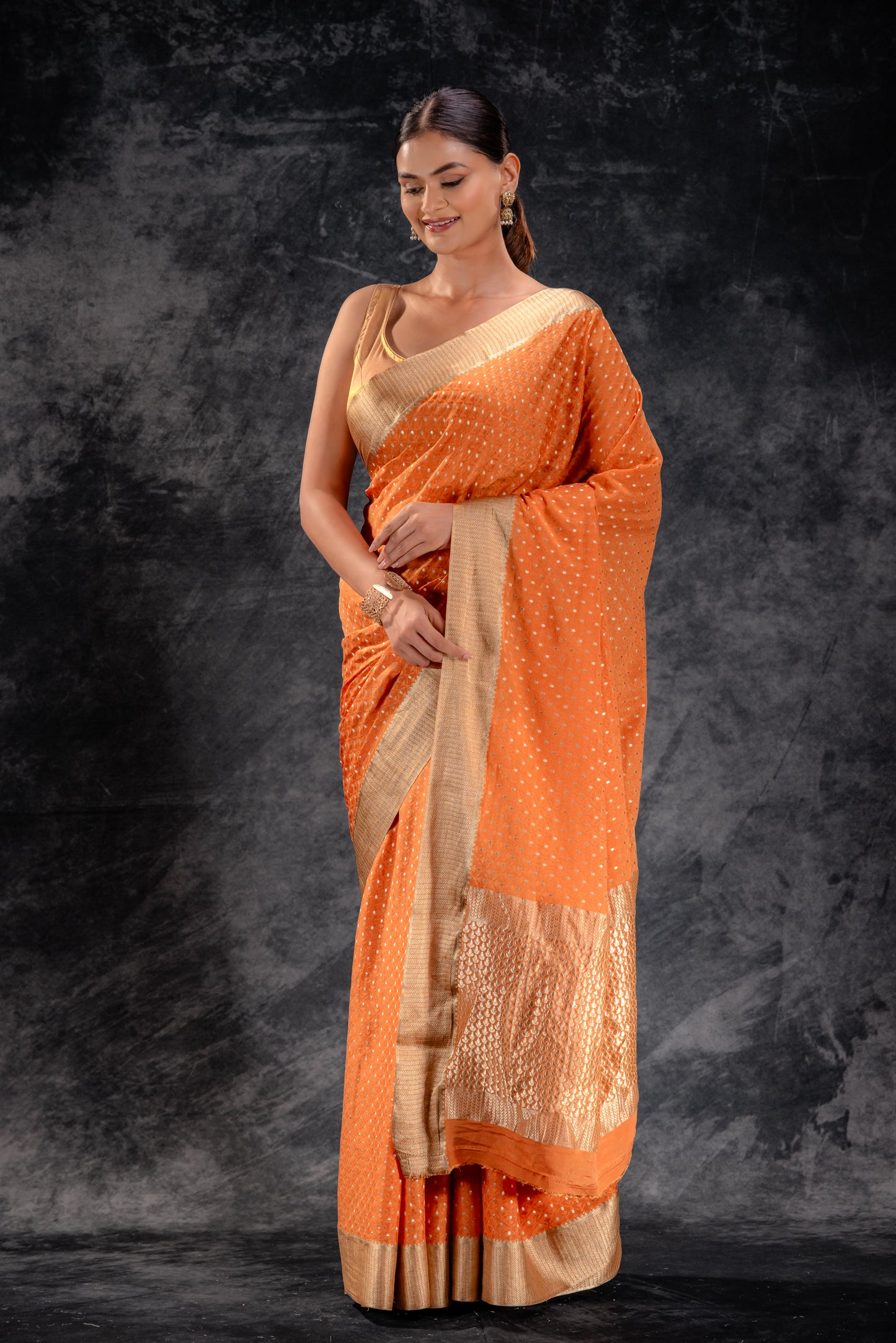 Burnt Orange Crepe Saree with Silver Buttas and Floral Jaal Texture