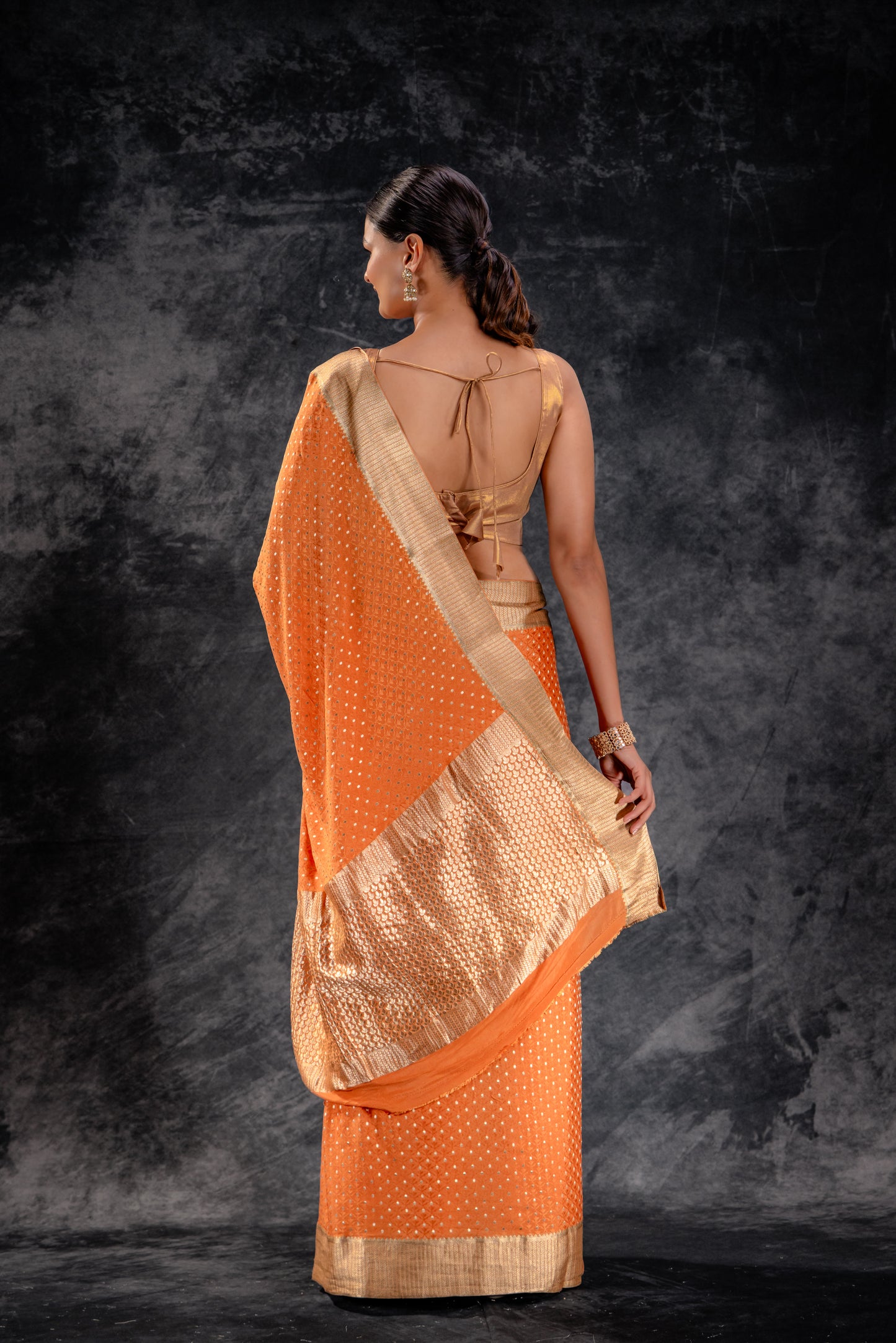 Burnt Orange Crepe Saree with Silver Buttas and Floral Jaal Texture