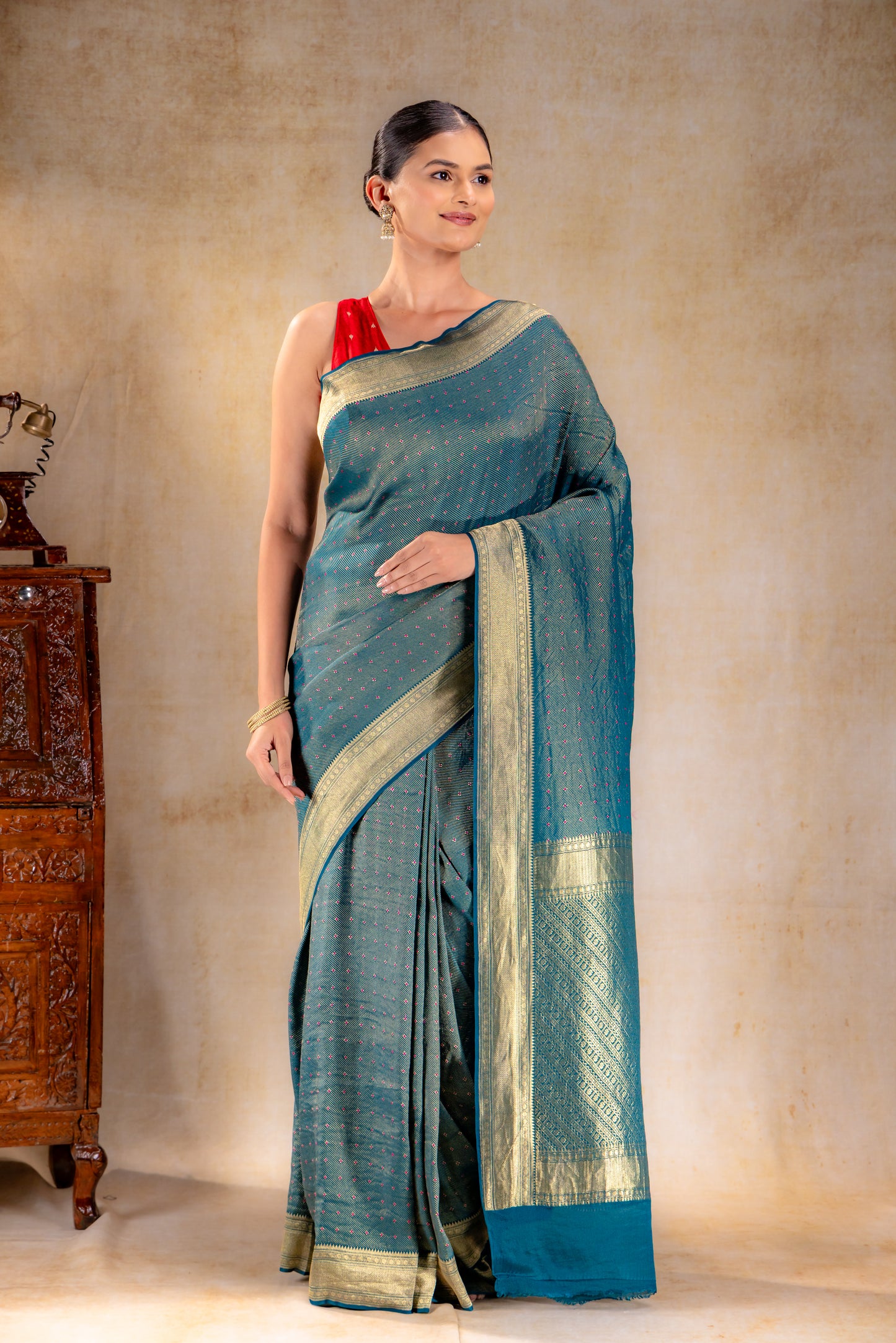 Peacock Teal Crepe Silk Saree with Rani Meena Buttas and Diagonal Zari Weave