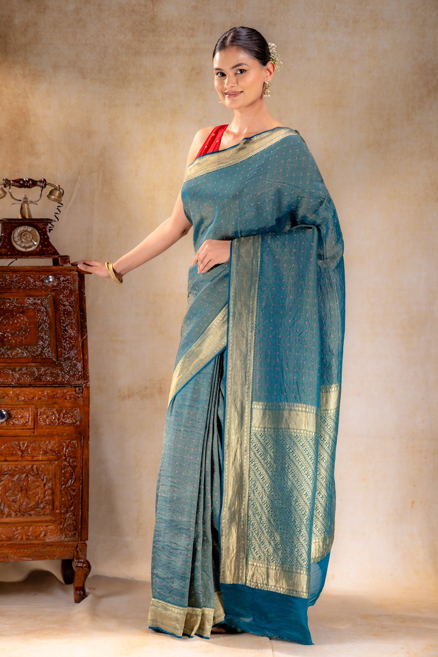 Peacock Teal Crepe Silk Saree with Rani Meena Buttas and Diagonal Zari Weave
