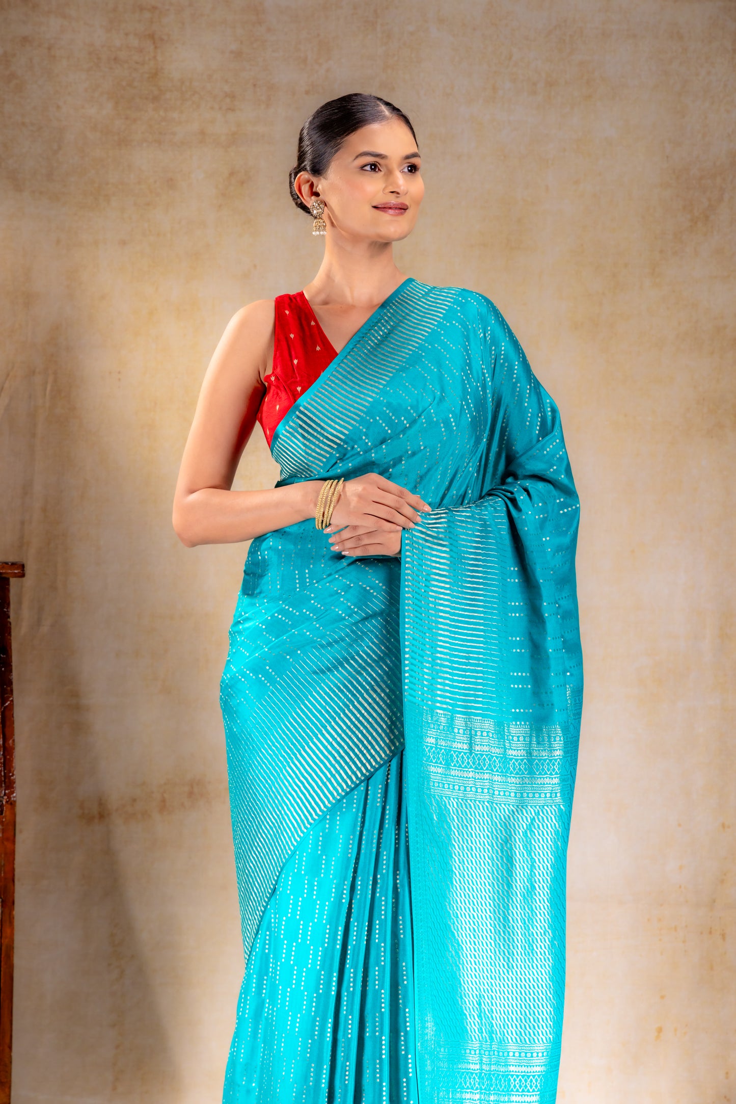 Peacock Blue Crepe Saree with Silver Vertical Buttas and Striking Zari Border
