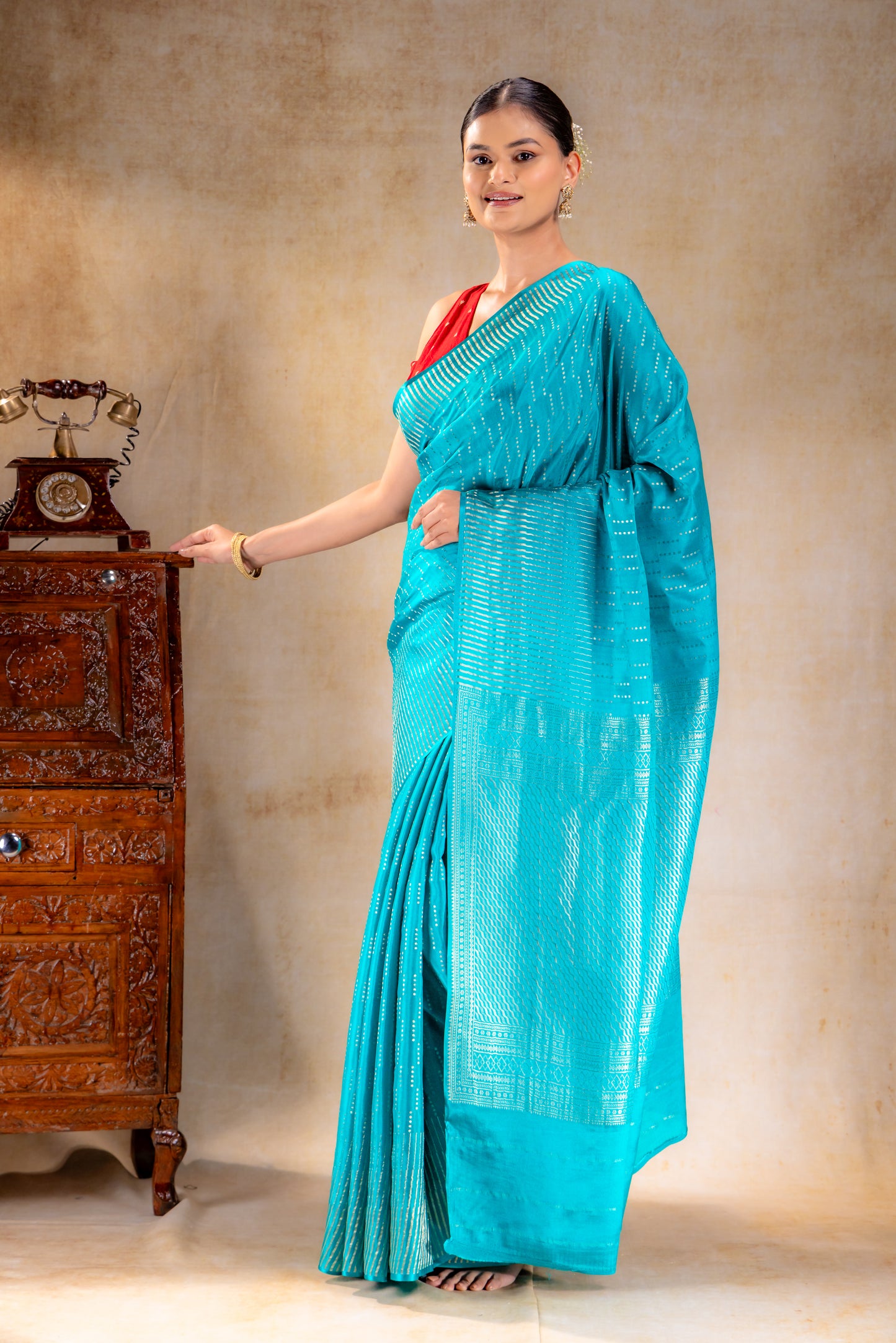 Peacock Blue Crepe Saree with Silver Vertical Buttas and Striking Zari Border