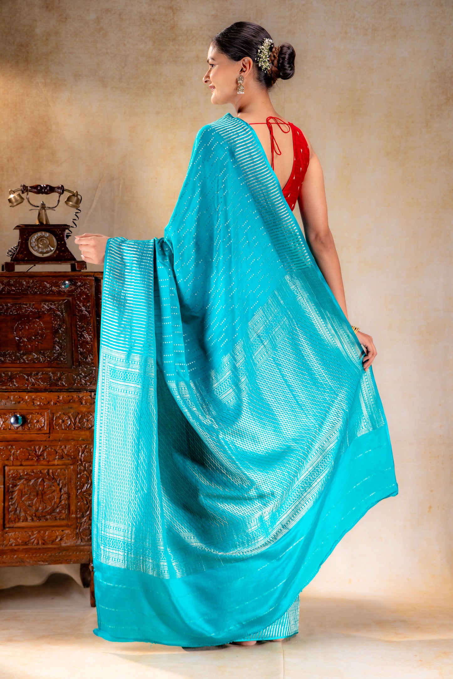 Peacock Blue Crepe Saree with Silver Vertical Buttas and Striking Zari Border