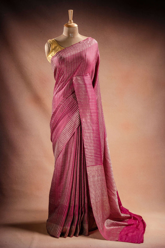 Pink Crepe Silk Saree with Zari Stripes draped elegantly on a mannequin showcasing its intricate zari stripes.