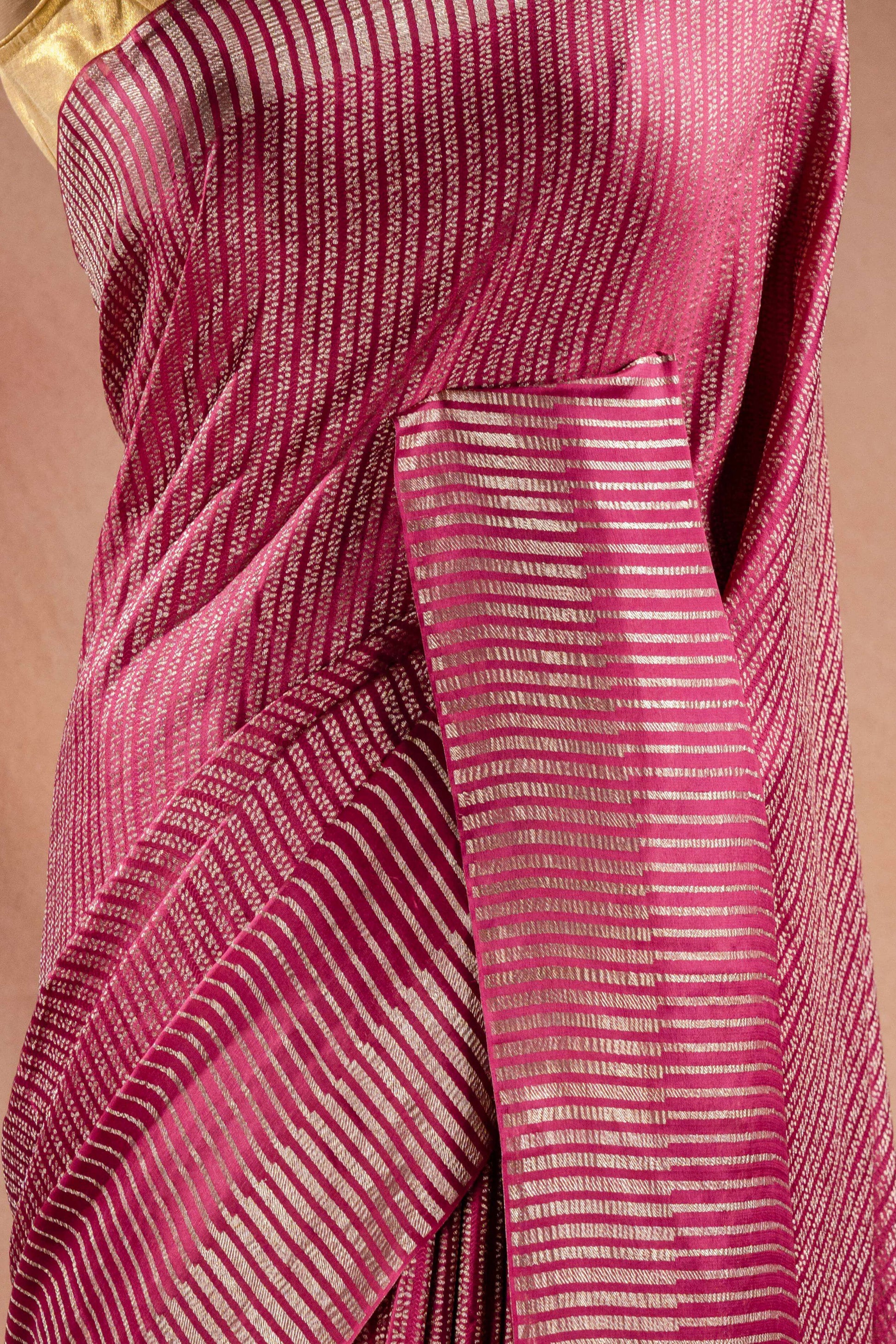 Pink Crepe Silk Saree with Zari Stripes showcasing elegant zari stripe weaving in a vibrant pink color.