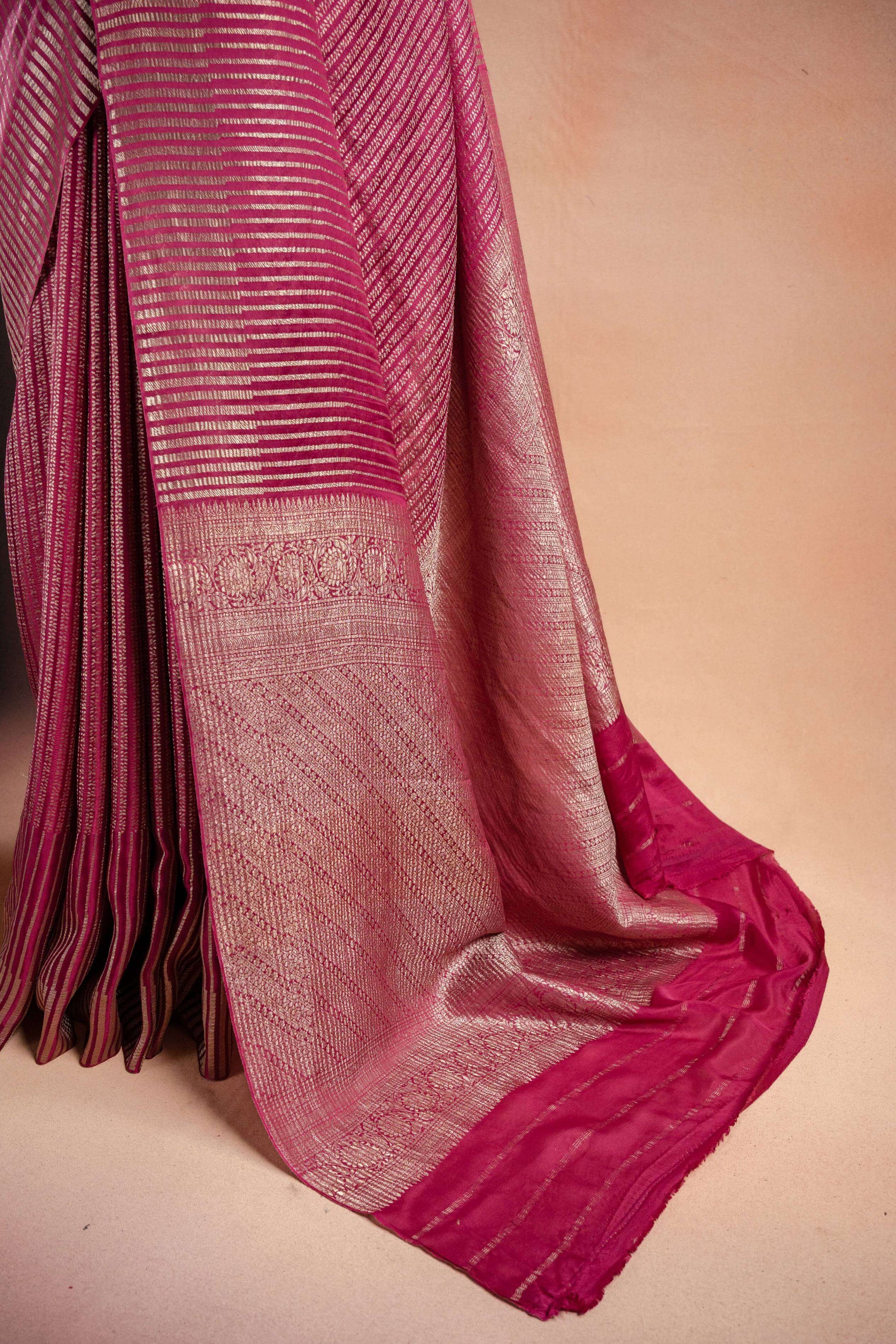 Pink Crepe Silk Saree with Zari Stripes elegantly draped, showcasing its exquisite zari stripe weaving and rich pink hue.