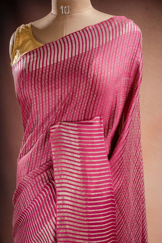 Pink Crepe Silk Saree with Zari Stripes elegantly draped showcasing beautiful zari stripe weaving.