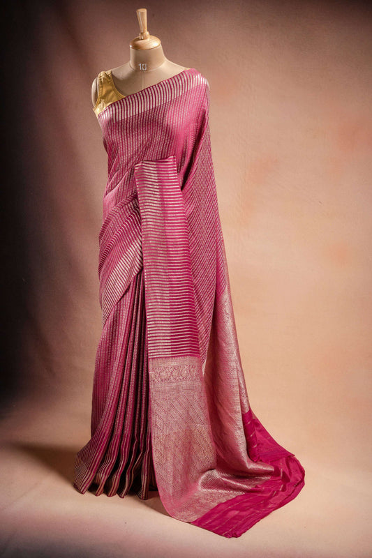 Pink Crepe Silk Saree with Zari Stripes elegantly draped, showcasing intricate zari stripe weaving.